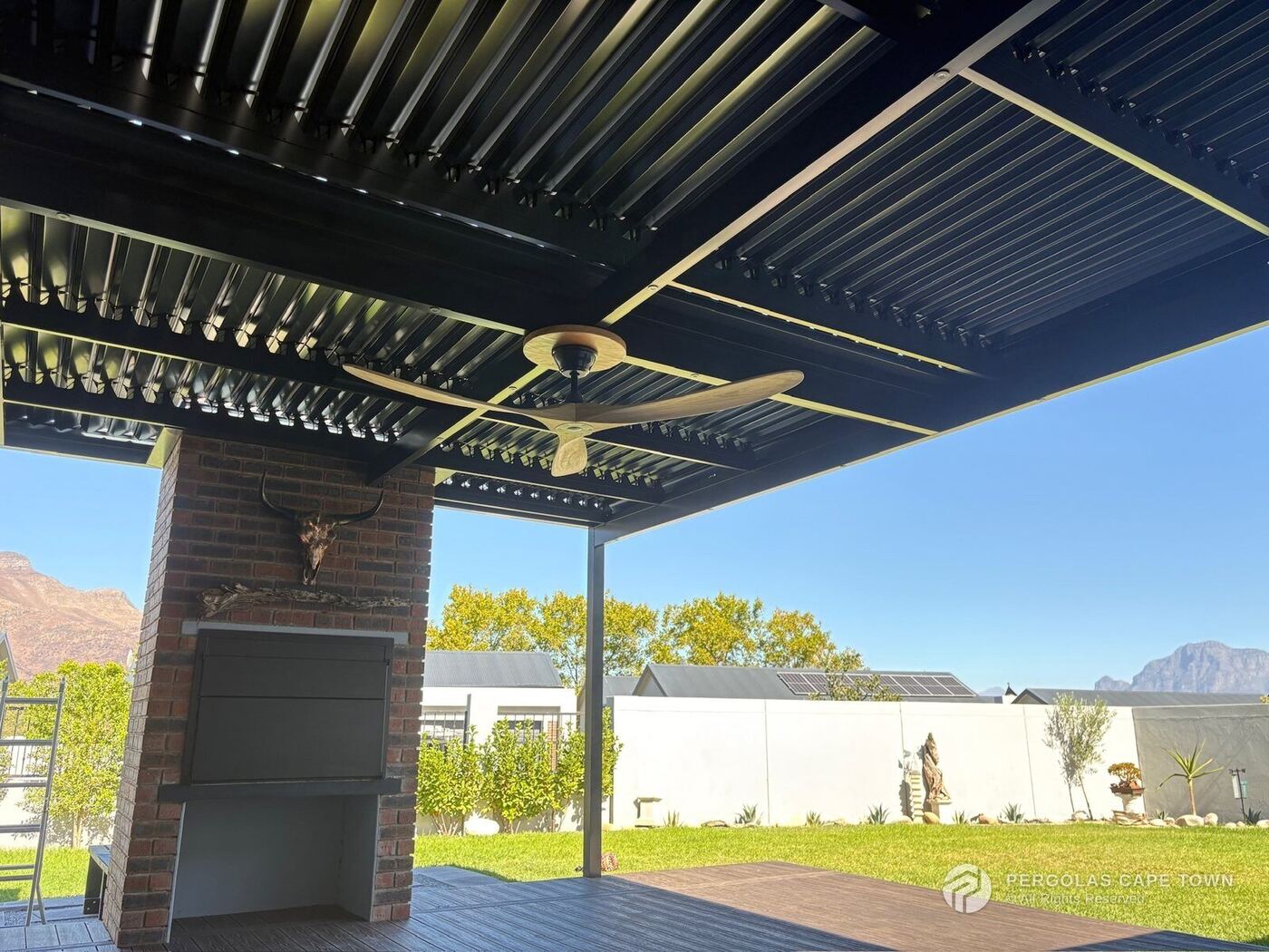 Full motorised louvre awning with a central fan