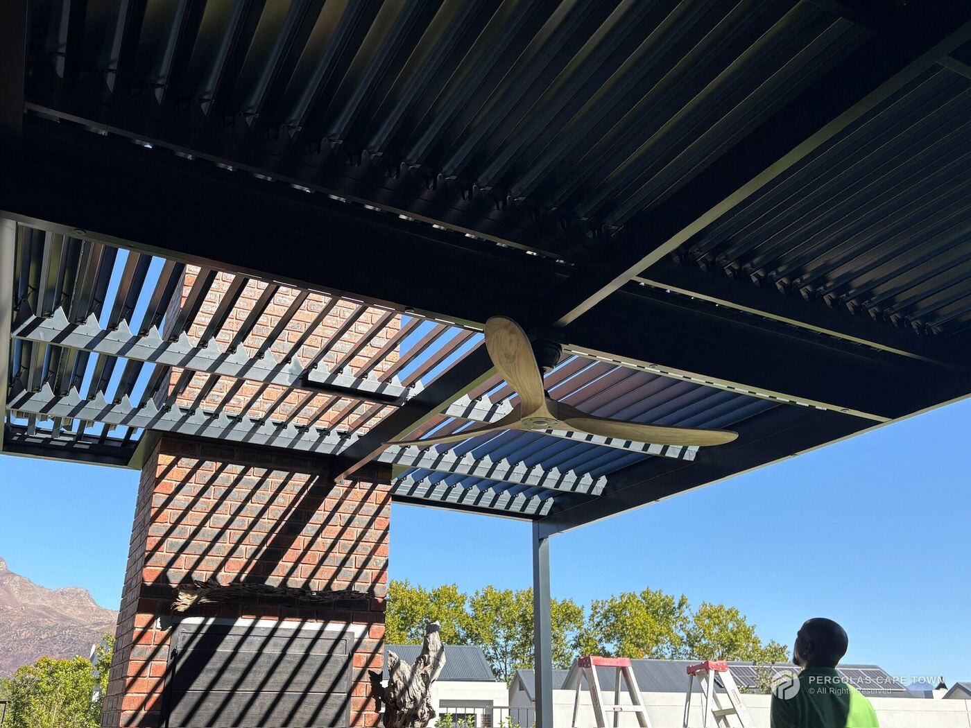 Motorised aluminium louvre roof with integrated ceiling fan, Cape Town