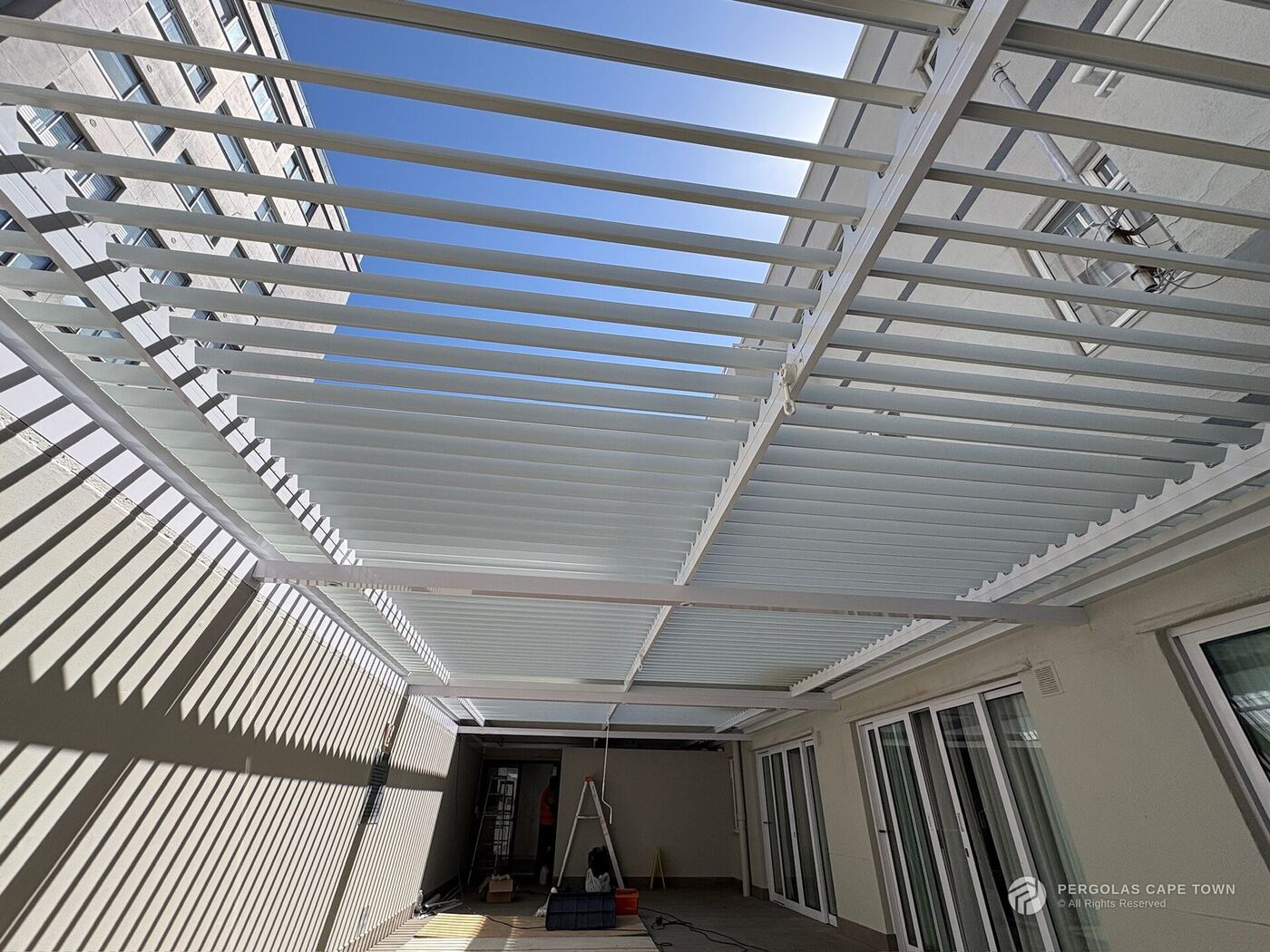 Charcoal aluminium louvre roof over a patio — Claremont, Cape Town