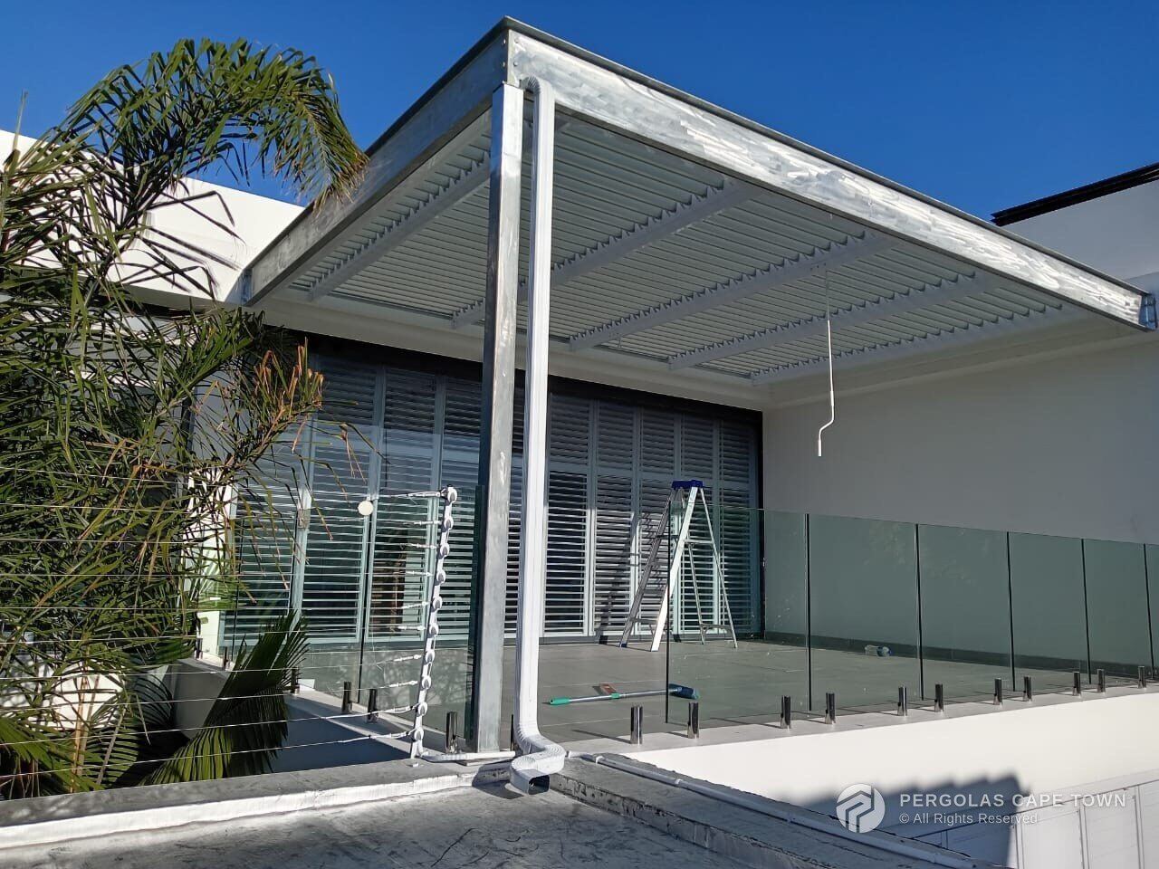 Bronze aluminium louvre roof on a coastal home — Hermanus, Western Cape