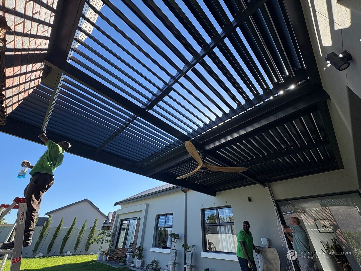 Aluminium Awnings installation crew fitting an aluminium louvre roof